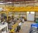 Elevated view of industrial machines, floor markings and the warehouse receiving door.